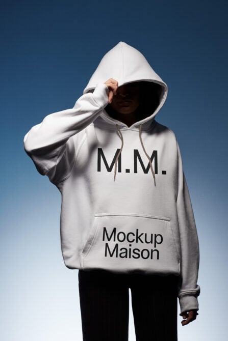 Hoodie mockup featuring a person in a white pullover with hood up showcasing Mockup Maison text on blue gradient background ideal for designers.