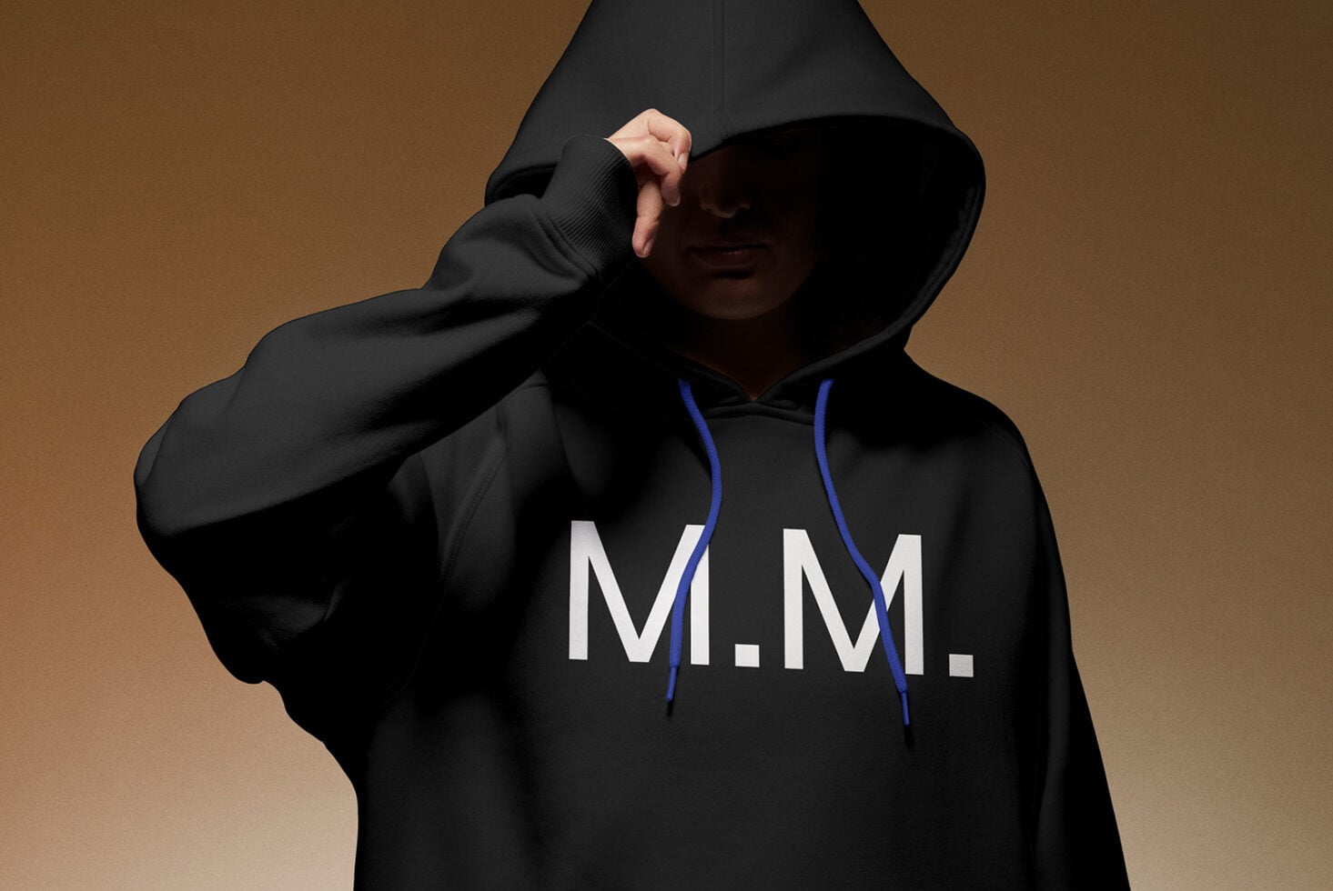 Person in black hoodie with blue drawstrings pulling hood over face