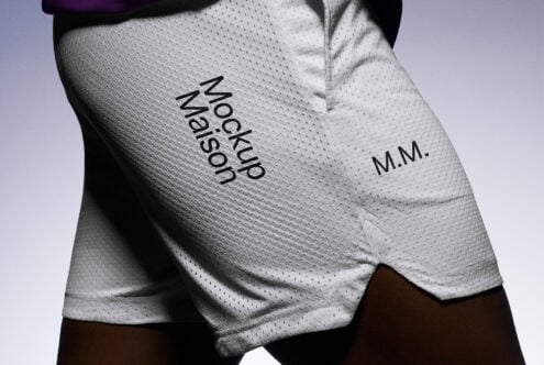 Close-up of white sports shorts showing logo Mockup Maison suitable for apparel mockups. Ideal for designers creating athletic wear graphics.