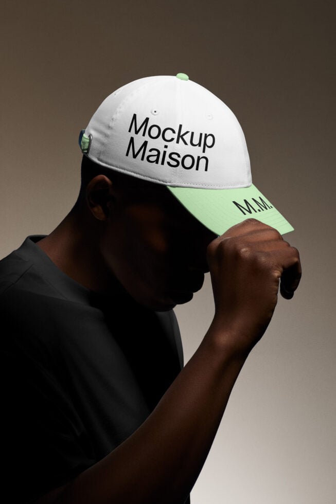 Person wearing a two-tone cap with Mockup Maison text suitable for branding and design mockups. Ideal for showcasing logo designs and apparel templates.
