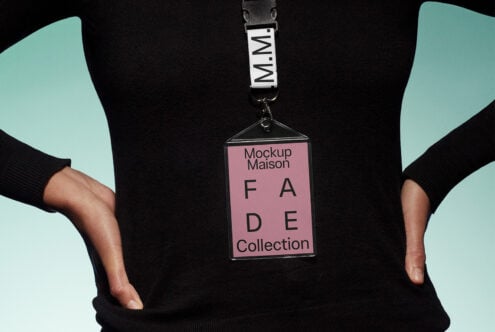 Lanyard ID badge mockup on person wearing black sweater with pink tag displaying text Fade Collection. Ideal for designers. Mockup, template, branding.
