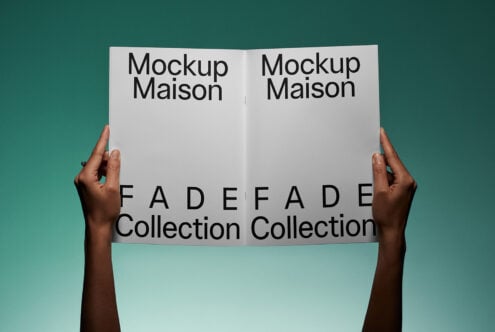 Hands holding a magazine spread with large black text FADE Collection on a teal background, perfect for showcasing graphic design mockups.