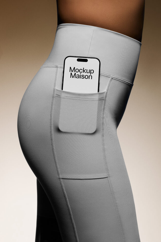 Phone mockup in gray leggings pocket showing screen. Perfect for apparel templates and technology designs. Ideal asset for digital designers.