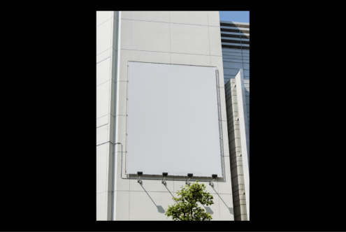 Urban building facade with large blank billboard mockup ready for design. Suitable for outdoor advertising graphics or digital art showcase.