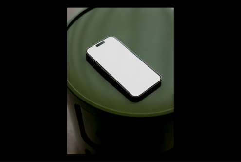 Smartphone mockup on green round table minimalist design in modern setting ideal for showcasing mobile app or website user interface templates
