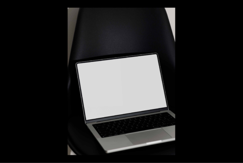 Laptop mockup on black chair isolated with blank screen perfect for showcasing web design templates digital assets ideal for designers graphic resources