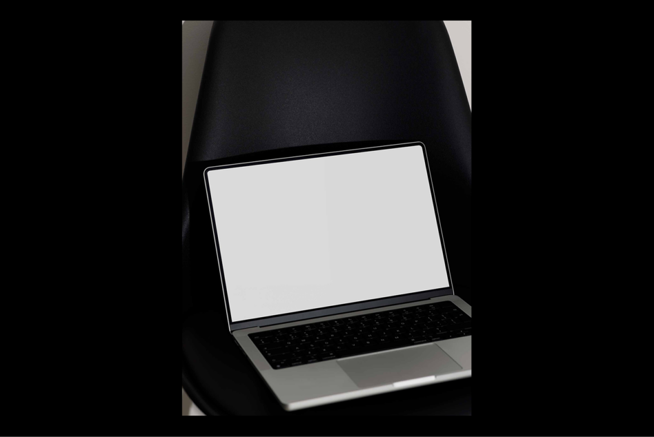 Laptop mockup on black chair isolated with blank screen perfect for showcasing web design templates digital assets ideal for designers graphic resources