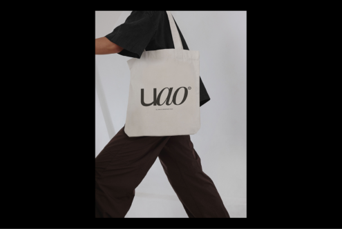 Canvas tote bag mockup with bold typography design worn by person in casual attire ideal for branding projects and promotional materials for designers.