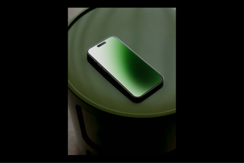 Smartphone mockup with green gradient screen on round table background design technology template for digital assets creative designers advertising