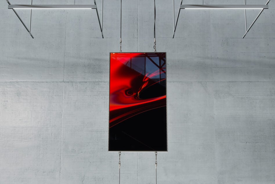 Red and black abstract artwork in vertical mockup frame suspended against a concrete wall ideal for designers creating modern digital graphics and templates.