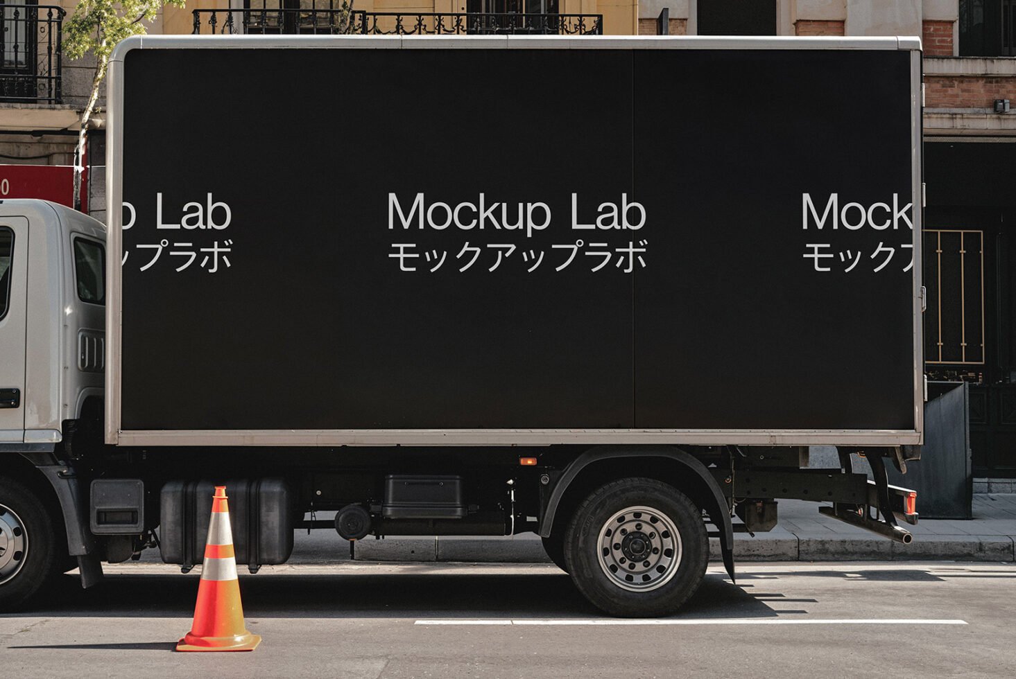 Black truck mockup parked on street with Japanese text. Perfect for vehicle branding. Ideal for designers to visualize advertising graphics.