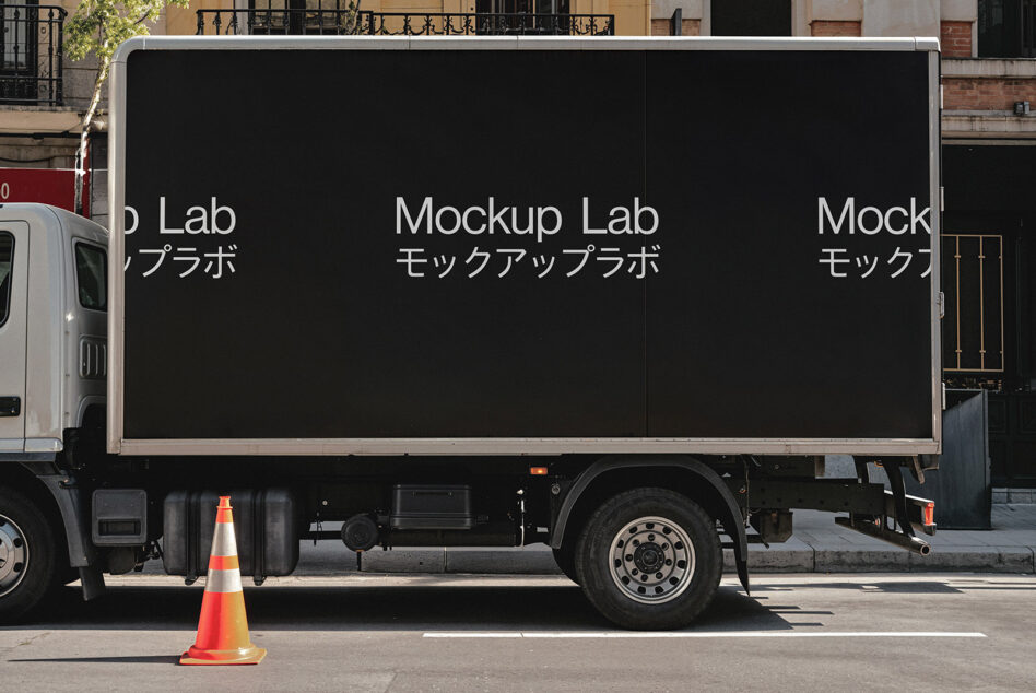 Truck billboard mockup with dark side panel repeating Mockup Lab text in multiple languages