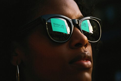 Close-up of person wearing reflective sunglasses with Mockup Lab text visible. Ideal for showcasing marketing mockups, digital assets, design templates.