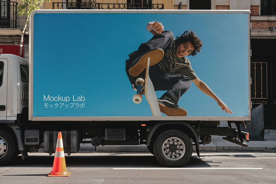 Delivery truck with blue side panel showing skateboarder mid-trick against bright sky