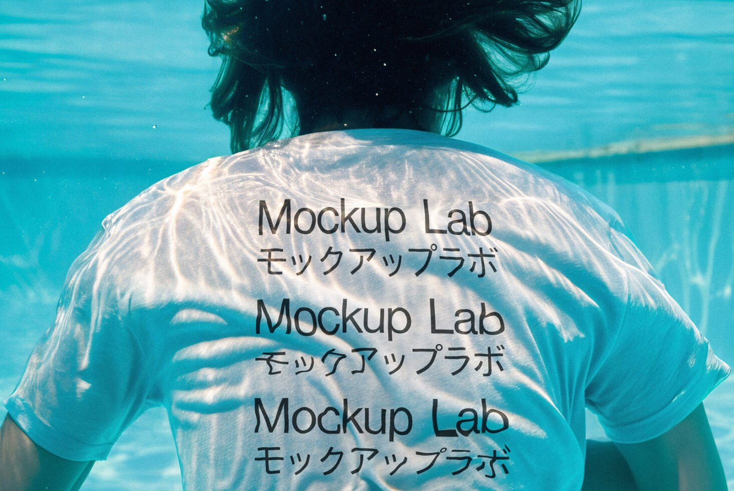 Underwater T-shirt mockup with Mockup Lab text in Japanese and English. Sunlight reflections on fabric. Ideal for design presentations and templates