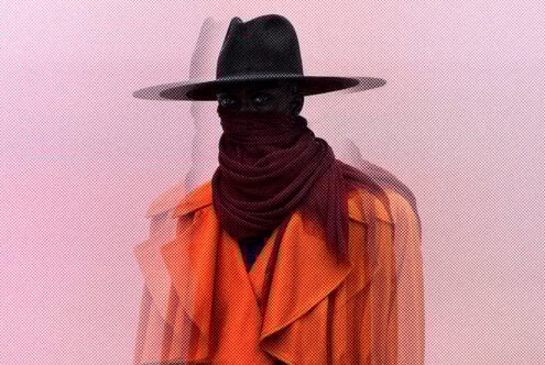 Mysterious figure wearing a wide-brimmed hat scarf and orange coat on abstract textured background perfect for graphic designers and illustrators.