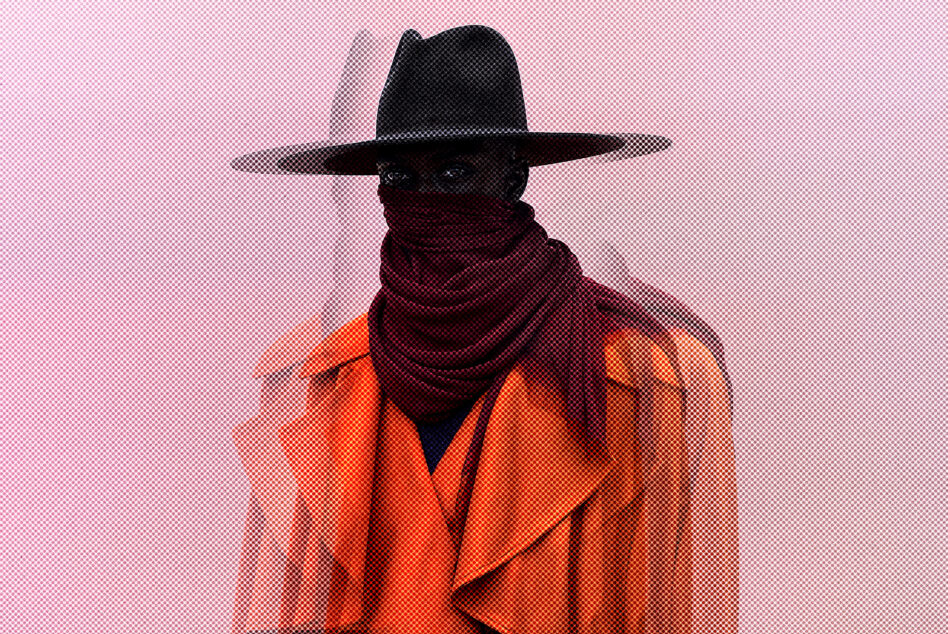 Mysterious figure wearing a wide-brimmed hat scarf and orange coat on abstract textured background perfect for graphic designers and illustrators.