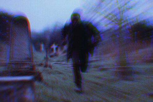 Man running through a misty graveyard with a dynamic blurred effect and dark tones, perfect for horror graphics or thriller movie posters.