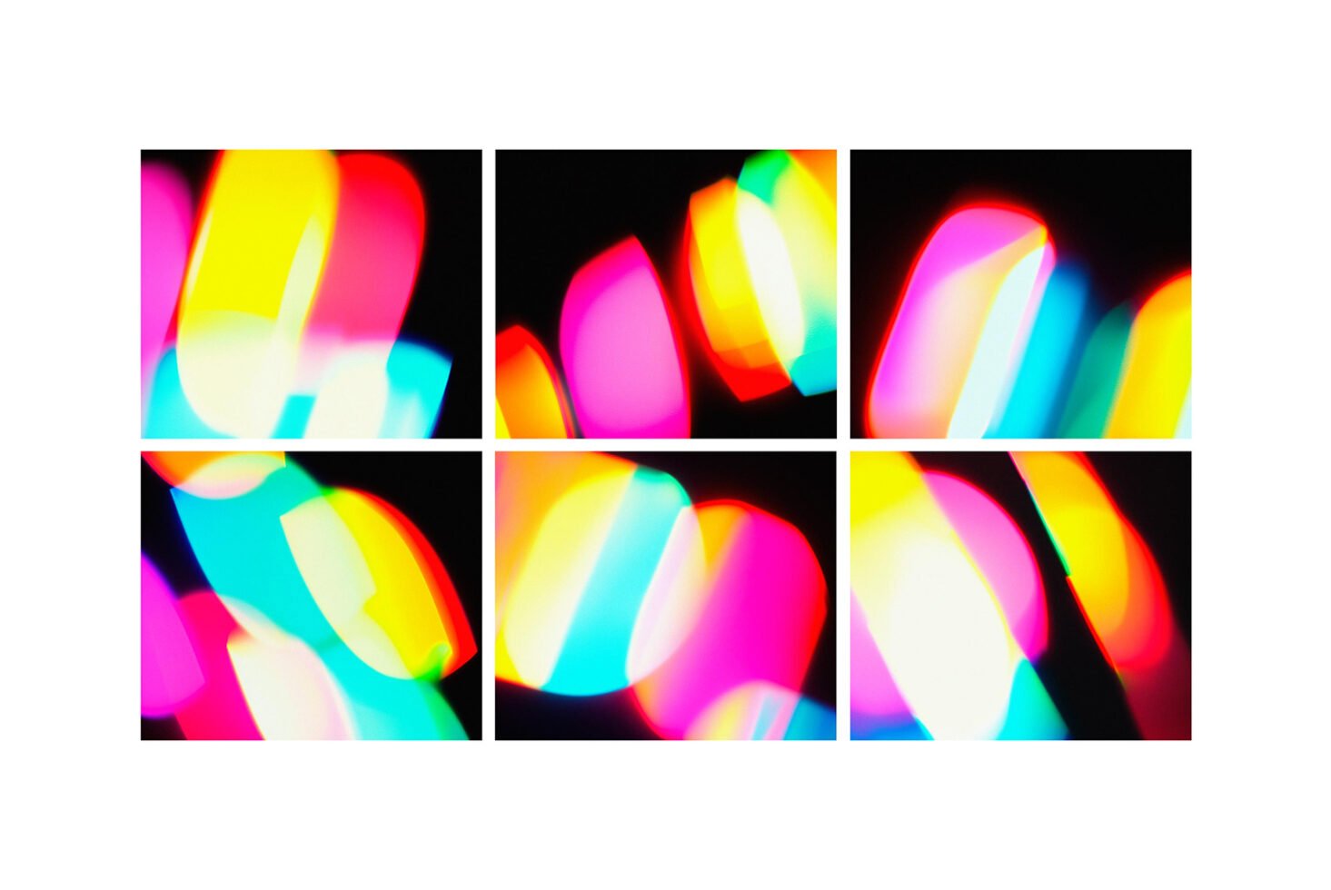 Colorful abstract light patterns with red, blue, yellow, and pink shapes on a black background. Ideal for graphic design, templates, creative projects.