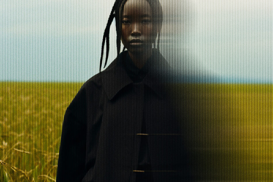 Woman in field with braids, cyan sky above yellow grass, scanline overlay