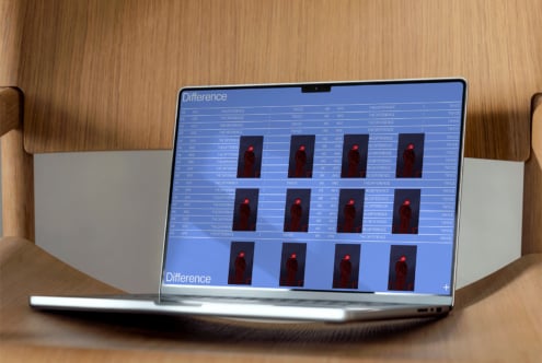 Laptop on a wooden chair showing a design software interface with repeated image thumbnails and text Difference ideal for design mockups and templates.