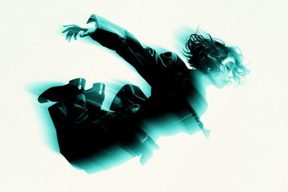 Person jumping mid-air with teal green color burst effect on cream backdrop