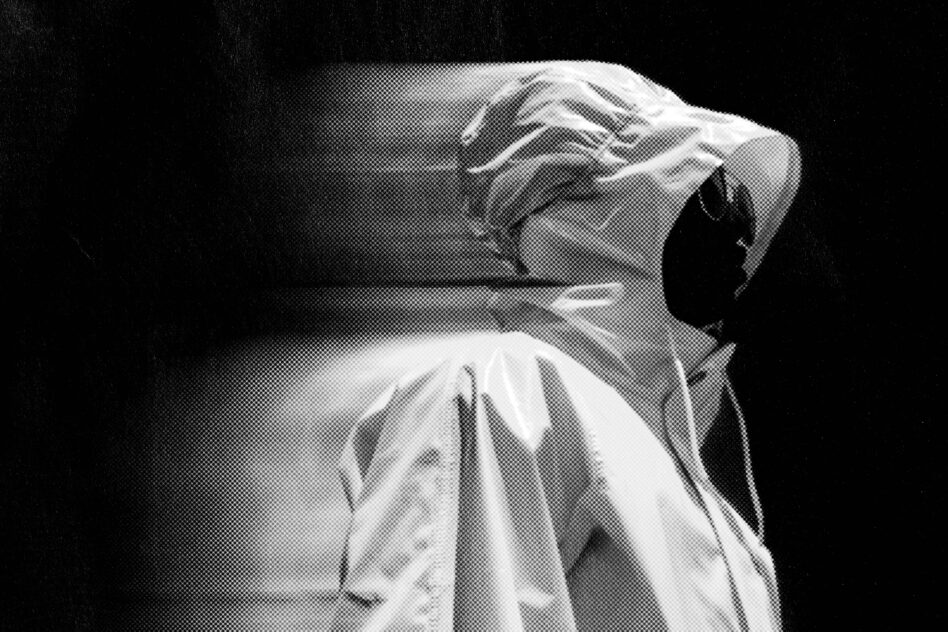 Black and white halftone image of a hooded figure showcasing dramatic lighting and shadow contrast suitable for graphics or design templates.