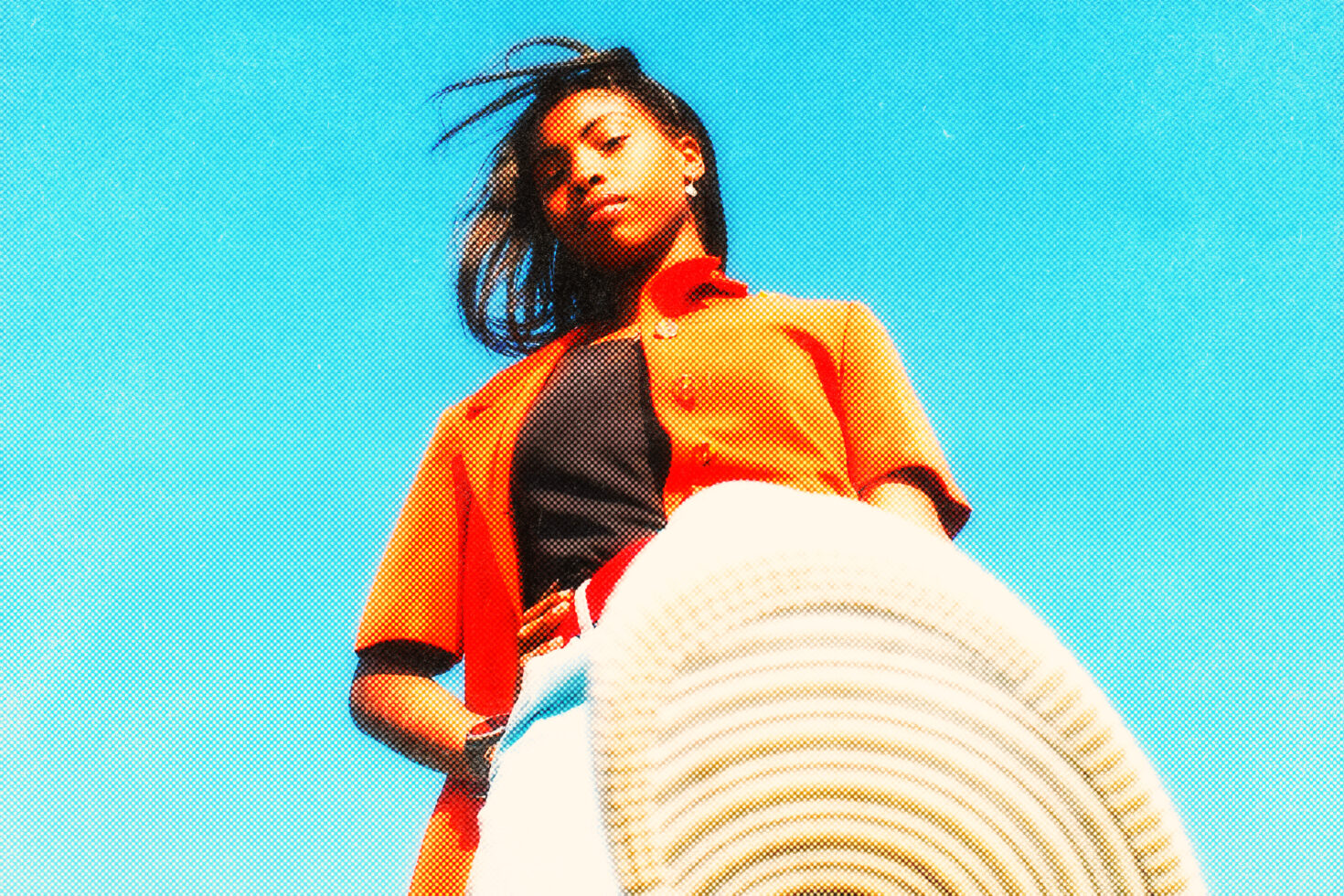 Vibrant halftone image of a woman gazing at the camera with a dynamic upward view. Ideal for graphic designers seeking bold color inspiration in templates.