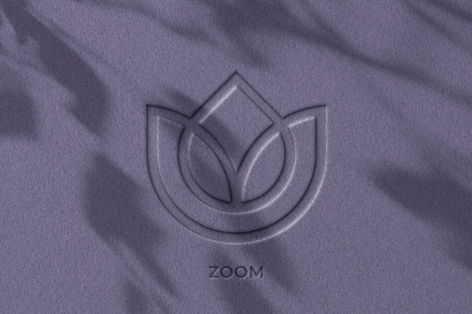 Embossed lotus leaf logo on purple fabric with subtle shadow effect