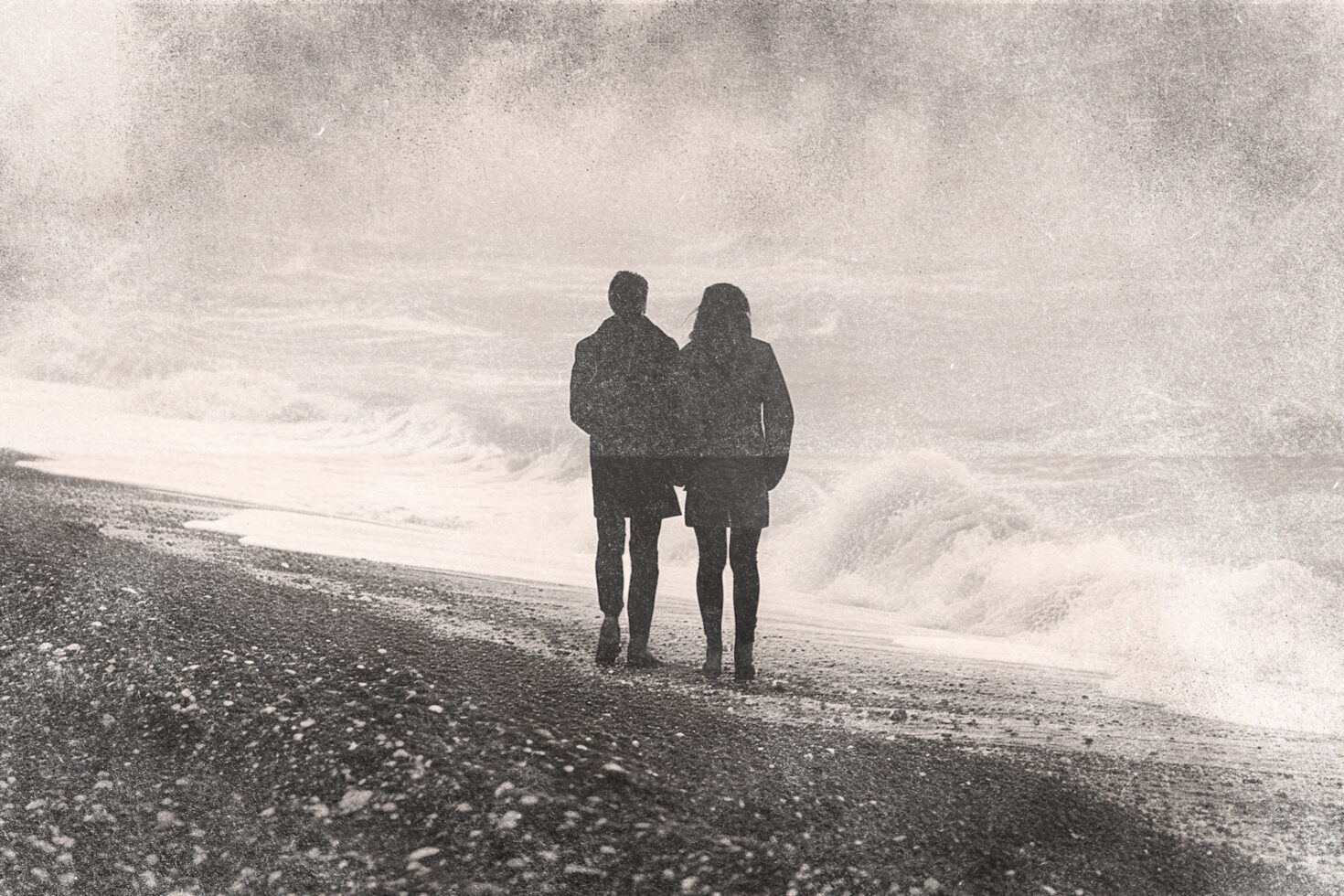 Vintage style graphic of a couple walking on a beach with waves in the background ideal for designers creating nostalgic templates or mockups.