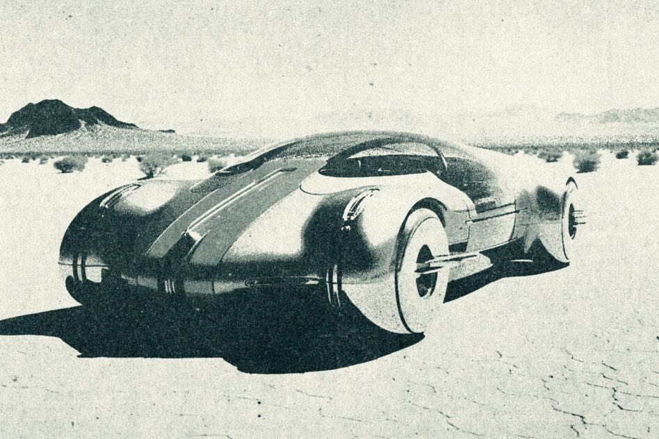 Sleek sports car parked in desert landscape with mountains in background