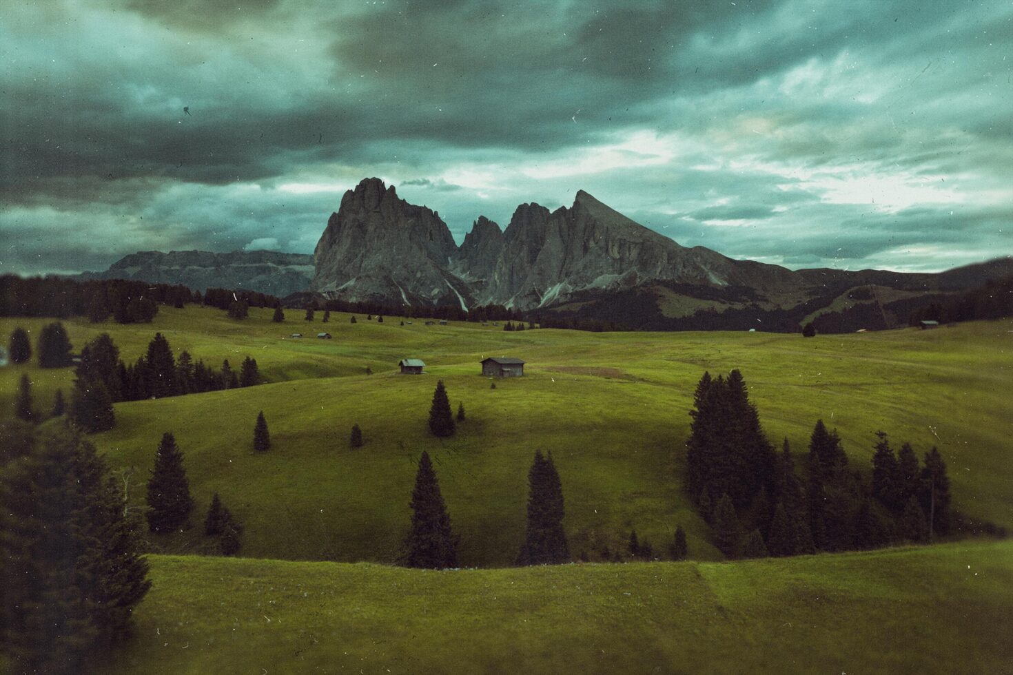 Scenic landscape with green fields, distant mountains, and cloudy sky suitable for templates or graphic design use. Ideal for nature-focused projects.