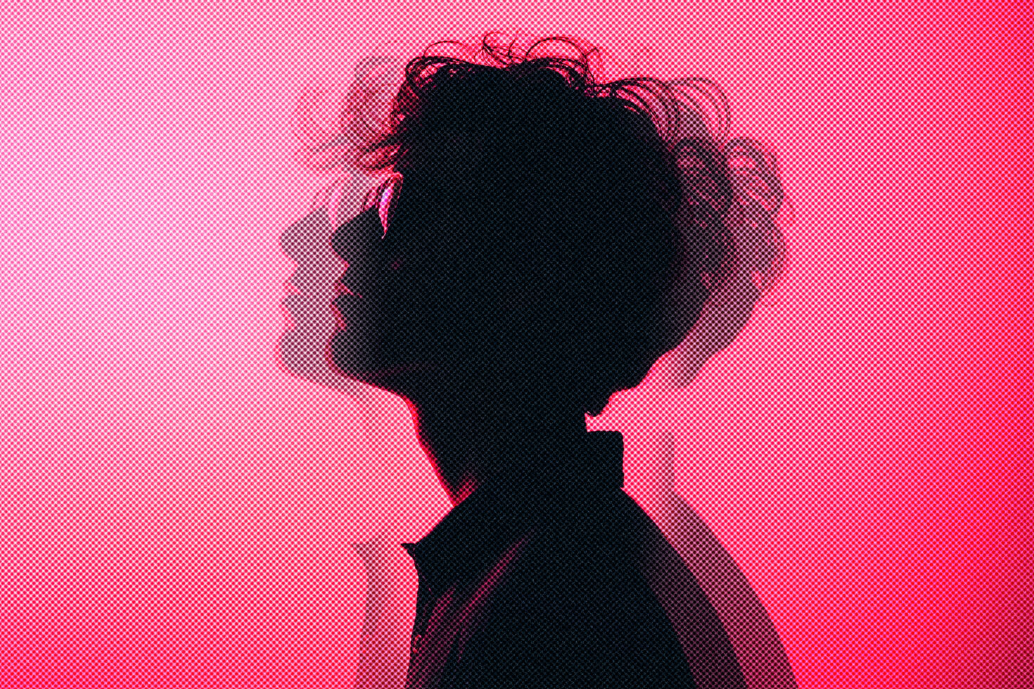Silhouette of a person with wavy hair against a pink dotted background, double exposure effect, abstract graphic design for creative projects and templates.