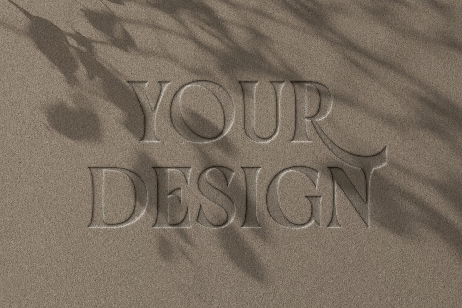 Text effect mockup featuring the words Your Design in embossed lettering on a textured surface with shadows. Ideal for designers seeking unique mockups.