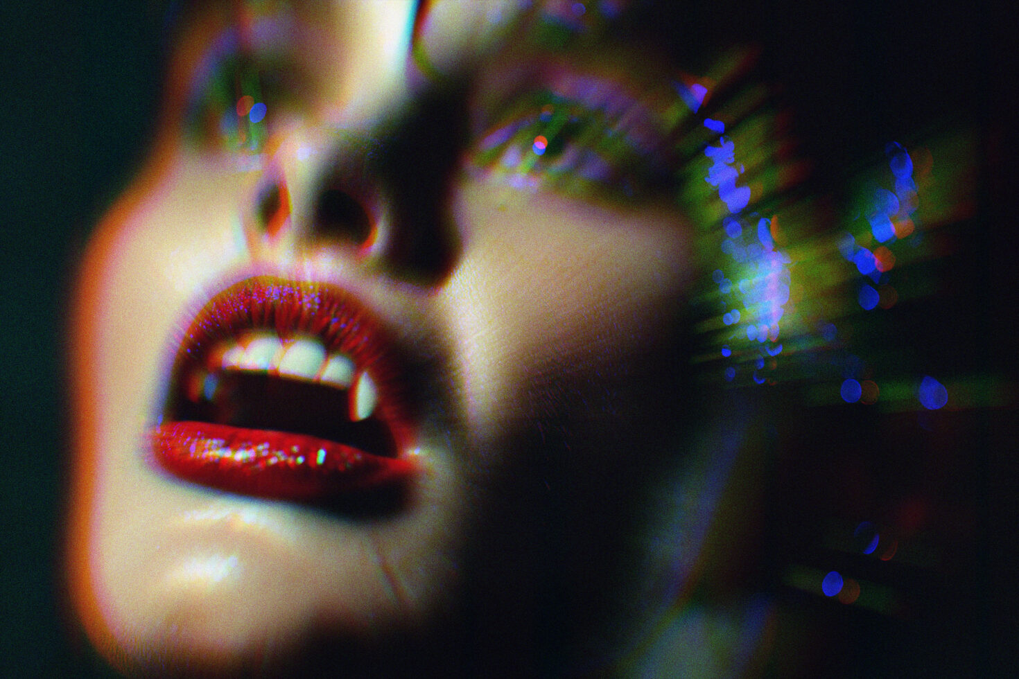 Close-up of a digital artwork of a face with red lips and rainbow light effects suitable for graphic designers focusing on vibrant color effects and textures.