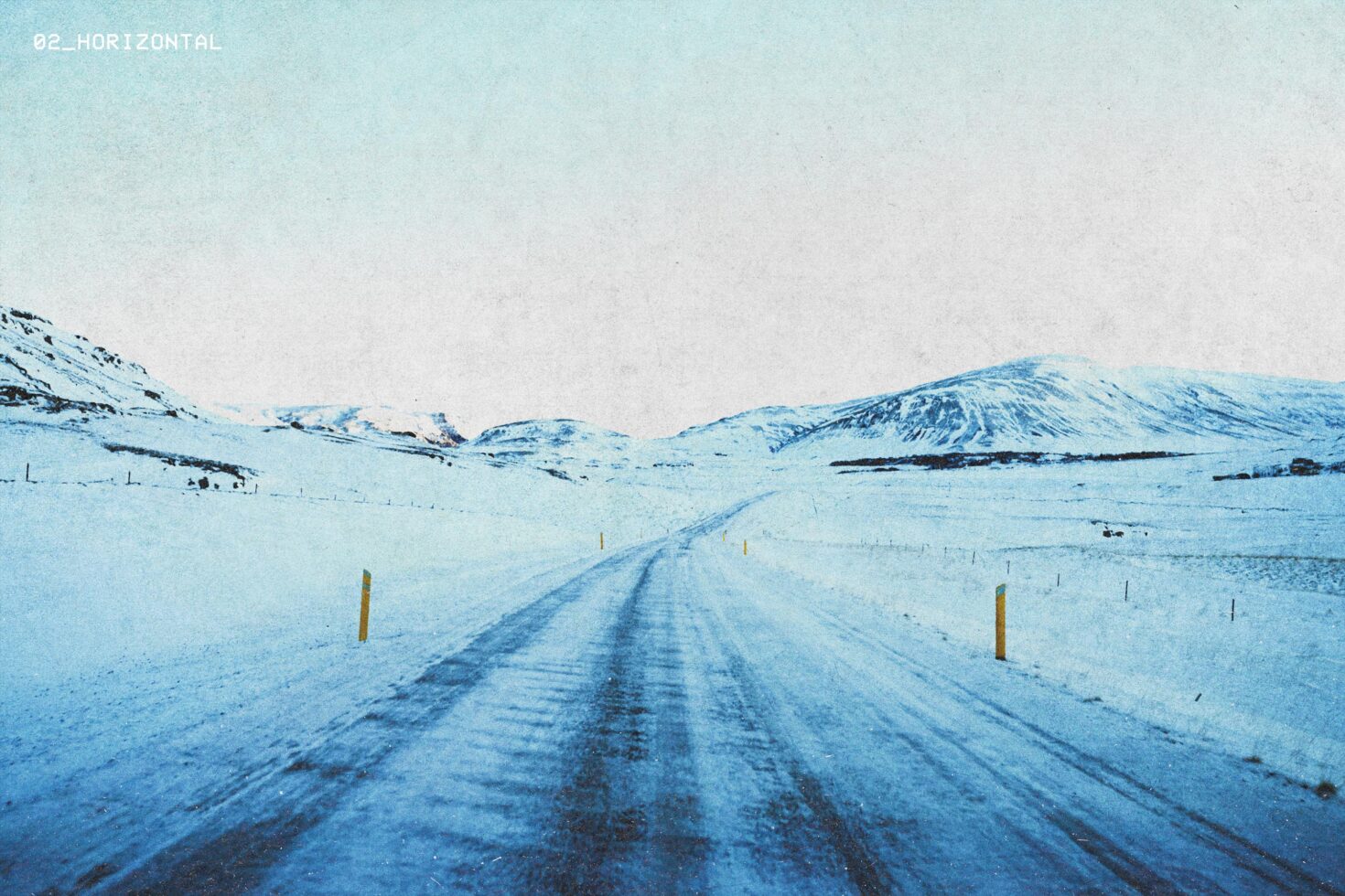 A snowy landscape with a road leading into distant hills. Winter scenery suitable for mockups, backgrounds, graphic design assets, and templates.