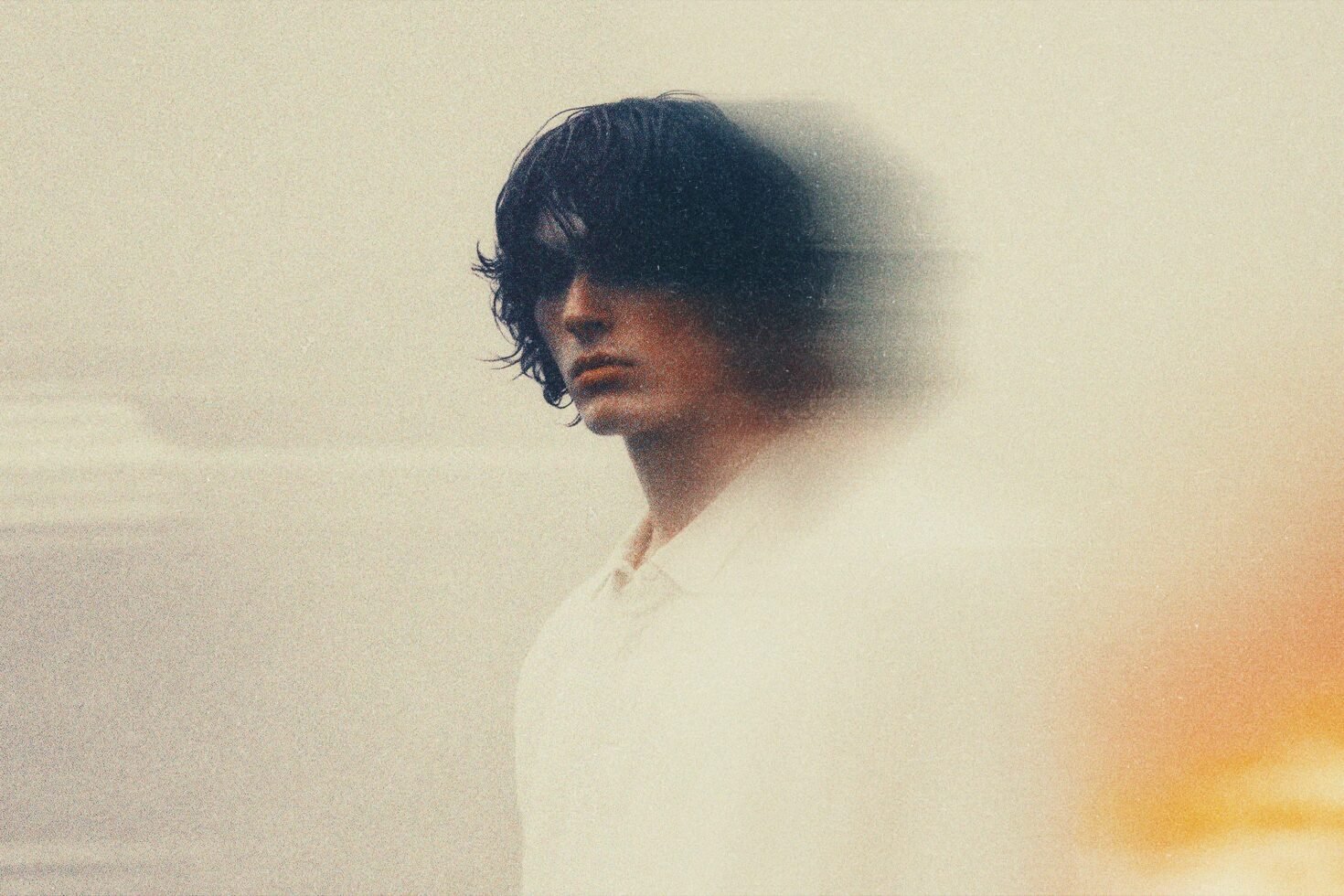 Blurred portrait of a man with dark hair, soft focus effect, artistic photography, warm tones, ideal for graphic design, templates, creative projects.