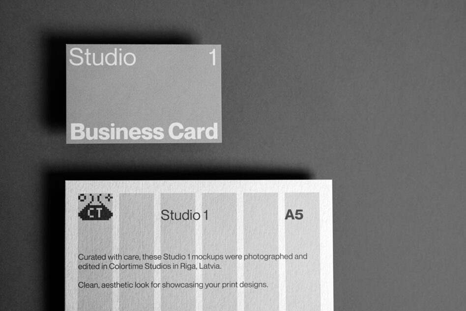 Light gray business card mockup with Studio 1 branding on dark background