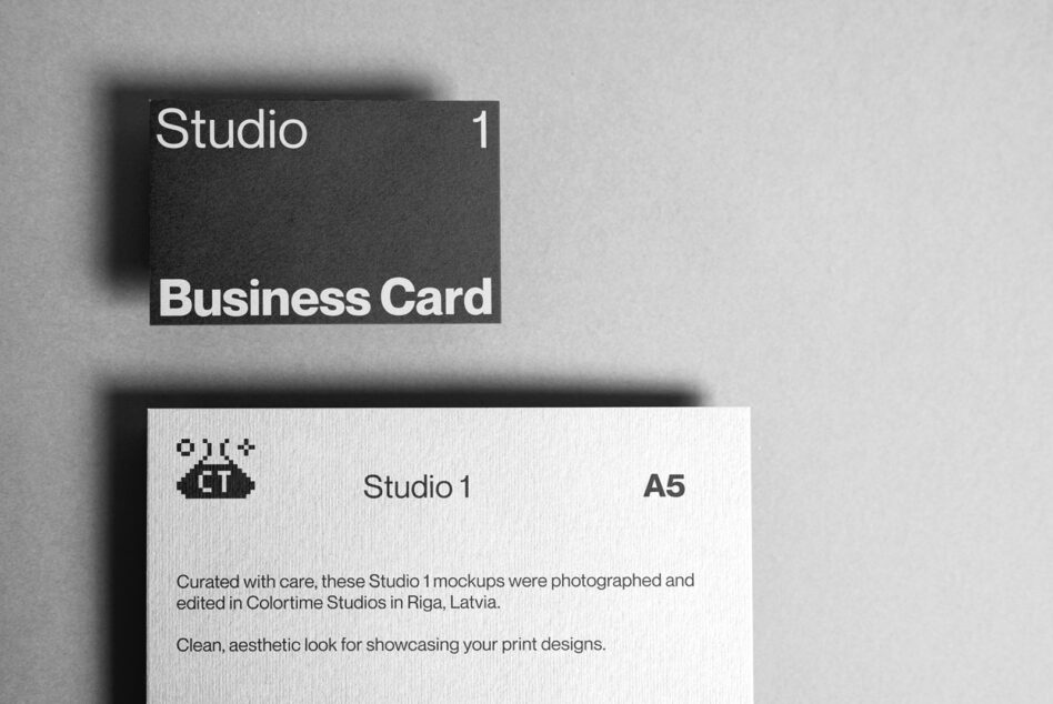 Dark charcoal business card mockup with Studio 1 branding on gray background