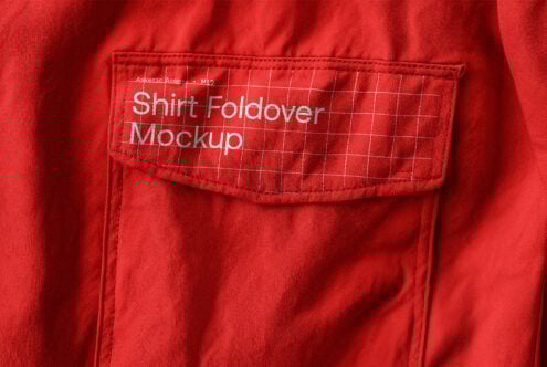 Red shirt close-up showcasing pocket design with grid lines and Shirt Foldover Mockup text suitable for apparel mockups and textile graphics designers