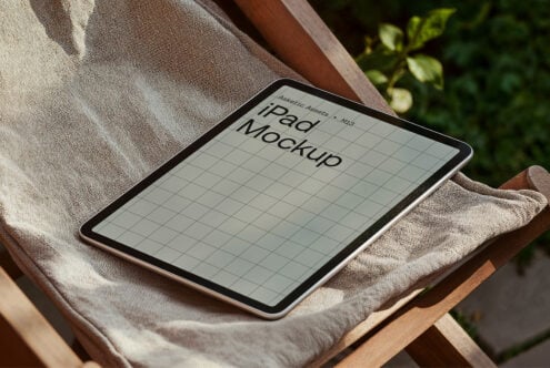 iPad mockup on a fabric surface in natural light showcasing grid layout for design presentations realistic tablet template for designers graphics
