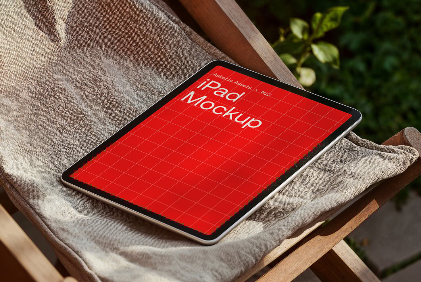 iPad mockup with red grid design displayed on a wooden chair with cushion ideal for graphic and template designers in digital asset marketplace