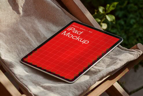 iPad mockup with red grid design displayed on a wooden chair with cushion ideal for graphic and template designers in digital asset marketplace