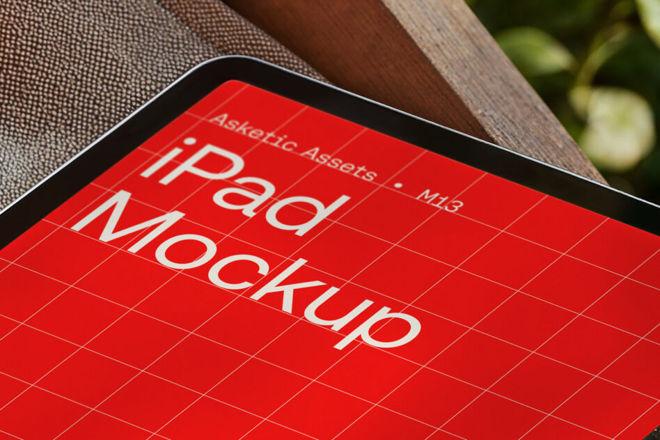 Red tablet mockup on brown fabric with white text overlay on grid background