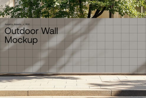 Outdoor wall mockup with grid pattern under tree shade ideal for showcasing designs in natural settings perfect for graphic designers and template creators.