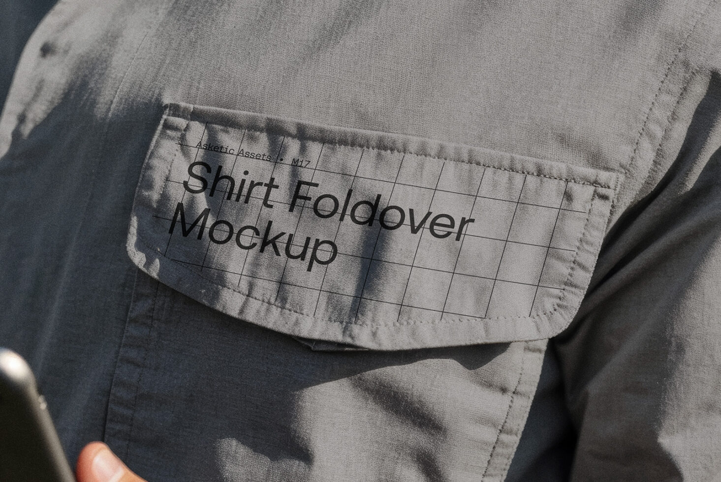 Close-up of a shirt pocket with grid pattern overlay displaying text Shirt Foldover Mockup ideal for design presentations fashion mockups Photoshop files