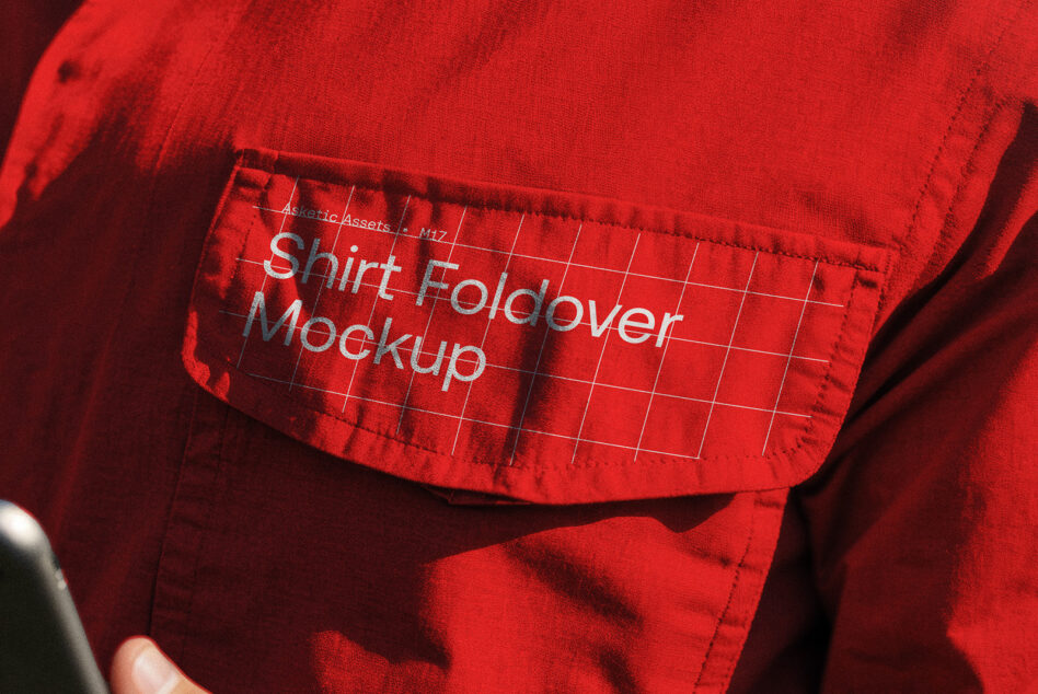 Red work shirt pocket with printed design in sunlight