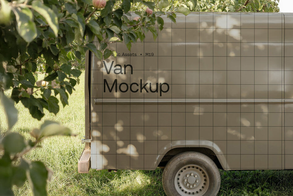 Van mockup showcased under trees with grid pattern for designers. Ideal for showcasing artwork and branding ideas. Keywords: van mockup, vehicle graphics.