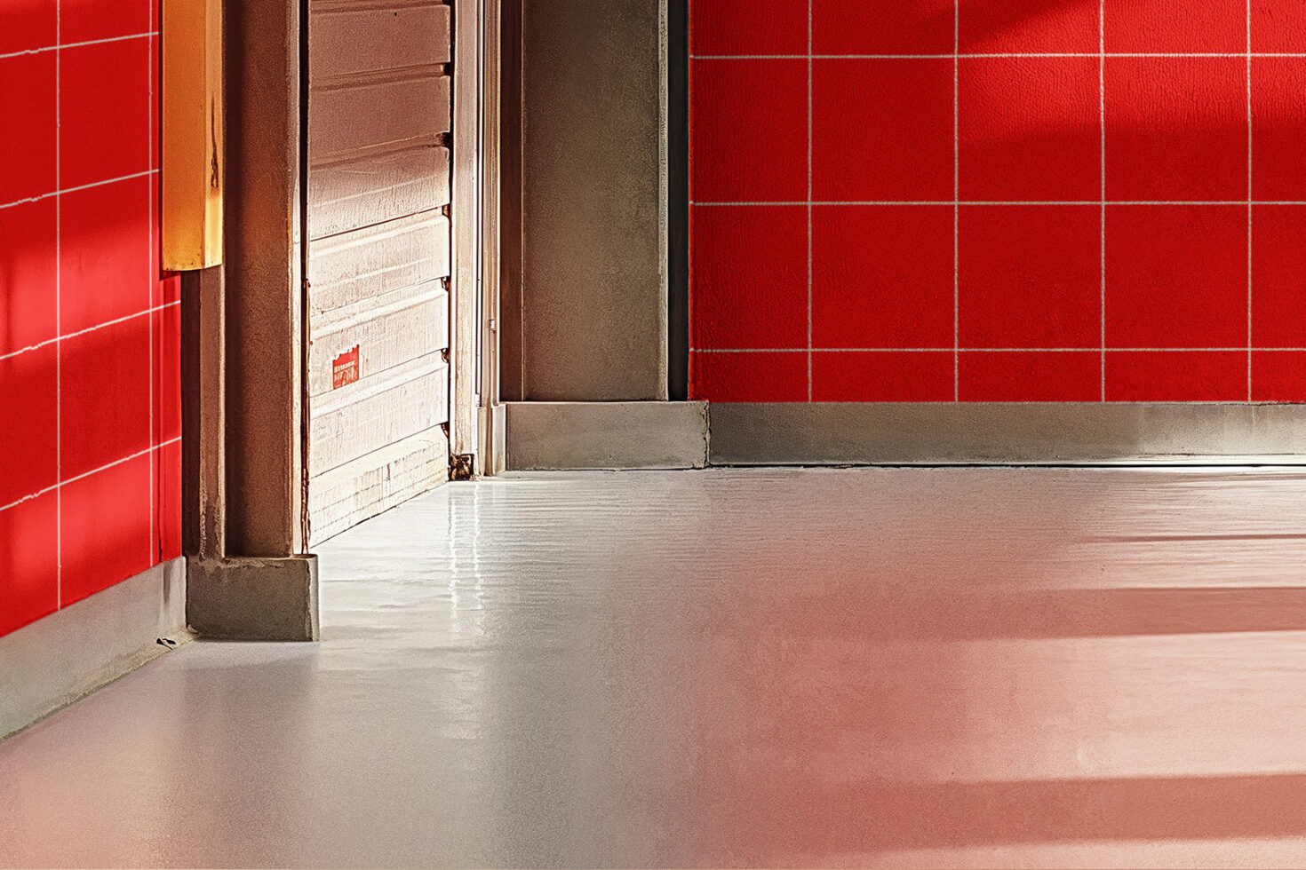 Red and beige interior wall with sleek reflective floor showcasing modern industrial design ideal for backgrounds or templates for designers.