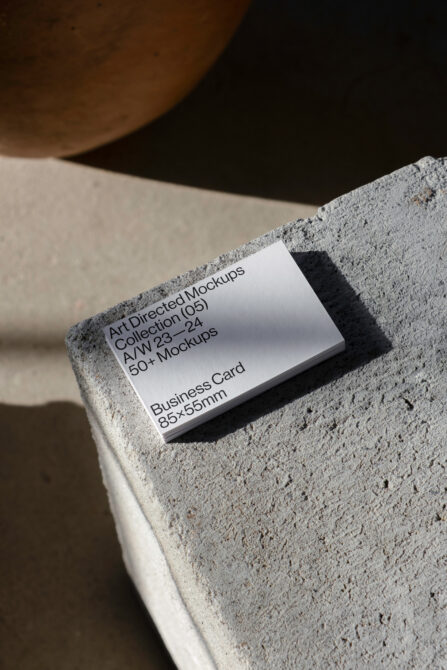 Stack of business card mockups on textured stone surface ideal for designers. Keywords: art directed mockups, business card, template design.
